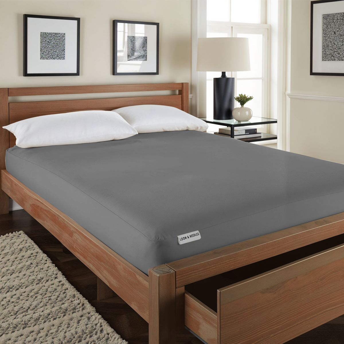 A gray Front view of the 100% waterproof mattress protector covering a mattress.