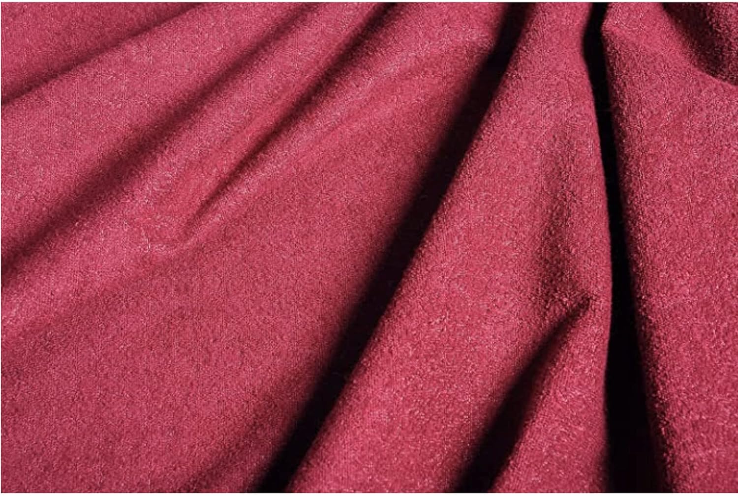 Close-up of maroon fabric with visible texture of 100% waterproof mattress protector